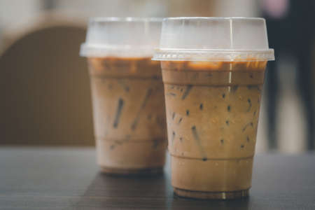 Two plastic take away cup of iced coffee on table at meeting roomの写真素材