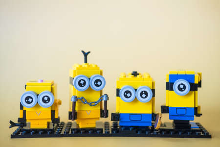 Bangkok, Thailand - January 31, 2022 : A row of cute LEGO minions built with LEGO bricks my hobbies on a yellow backgroundのeditorial素材