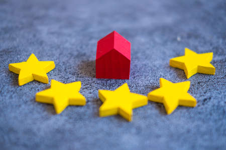 Small red wooden house with rating star. Concept of the best housing and best service, a high score, home appraisal conceptの写真素材