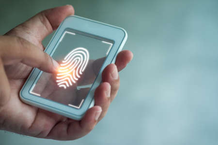 Man scan fingerprint biometric identity and approval. Fingerprint scan provides security access with biometrics identification. Business technology safety internet concept.の写真素材