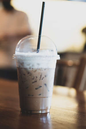 iced mocha coffee with milk on wood table in cafeの写真素材