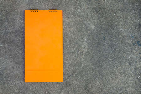 Orange blank desktop calendar on a stone backgroundの写真素材