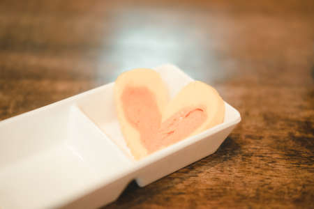 Tamagoyaki or sweet egg, heart shaped. Selective focus.