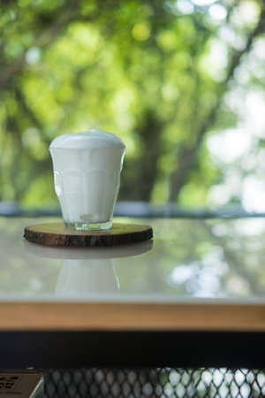 Fresh milk in glass on a wood table, close upの写真素材