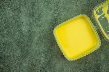 Cheese sauce in a plastic take away container. Tasty cheese sauceの写真素材