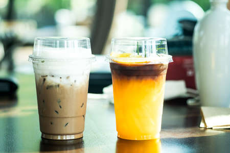 Iced Mocha coffee and iced americano black coffee mix of orange juice at cafe