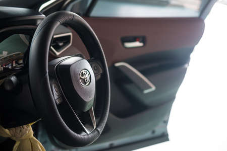 Bangkok, Thailand - MAY 22, 2022 : Close up of the steering wheel of the Toyota brand is controlling when driving in Corolla CROSS 1.8 Litre Hybrid engine 4th generation.のeditorial素材