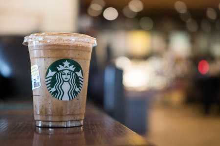 Bangkok, Samut Prakan - May 29, 2022 : A glass of Almondmilk White Chocolate Affogato Frappuccino from Starbucks coffee on the tableのeditorial素材