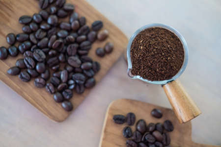 Roasted coffee beans and coffee powder (ground coffe). Selective focus on ground coffeの写真素材