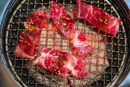 Top view of premium rare slices many parts of beef with high-marbled texture on stone plate served for Yakiniku (Grilled Meat).の写真素材