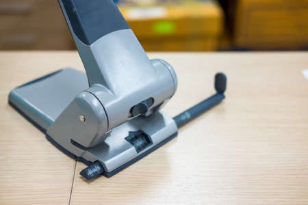 Big paper punches on the wooden table. Close upの写真素材