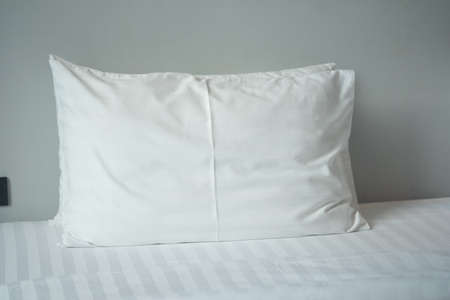 Big white pillows on white bed close up.の写真素材