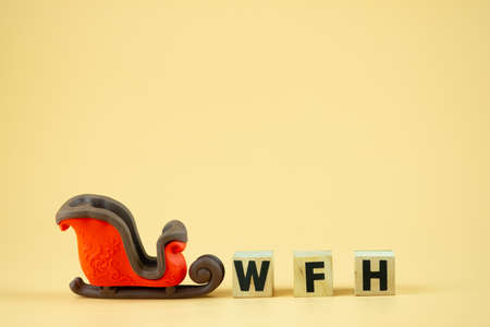 Christmas sleigh with wood blocks word of WFH. Concept quarantine at home during outbreak coronavirus spreading worldwideの写真素材