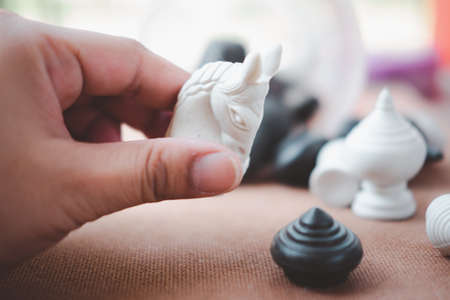 Man puting Thai chess horse. Brain games and indoor sportsの写真素材