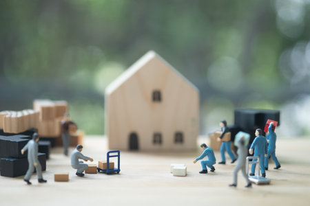 Miniature worker action moving  thing to house. House moving business concept. House moving business...