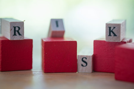 Risk assessment, decision to accept business result in uncertainty, unpredictable situation concept, cube wooden block with alphabet building the word RISK.の写真素材