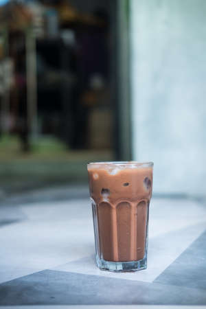 Iced mocha coffee, shot of espresso coffee mixed chocolate put in ice in glass, close up