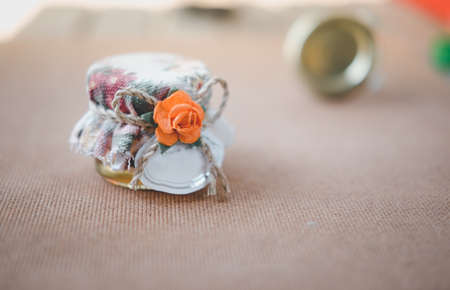 Honey Bottles with labels for wedding favors on wood background.の写真素材
