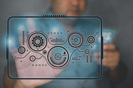 Technician manager holding tablet and touch modern virtual screen interface to control, a virtual...