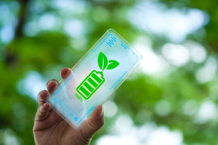 Mobile phone battery icon full of energy from nature. Renewable energy technology, solar charging a...