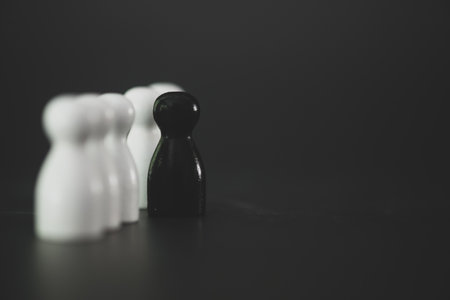 The black wooden figures stepped out of line to lead with each other figures and show different thinking ideas. Concept of leadership, leadership. Confidence and selection of qualified personnelの写真素材