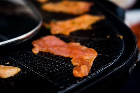 Thai barbecue pig pan grilled with electric stove. Barbecue pan or Moo Kra Ta in Thailand language.の写真素材