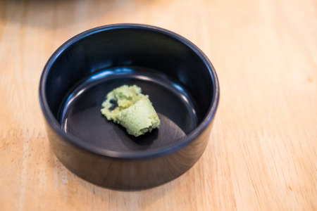 A little wasabi on a black bowl. Close upの写真素材