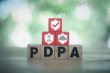 Personal Data Protection Act or PDPA concept. PDPA wood block blocks with shield, human and cloud...