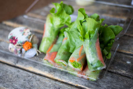 Roll of salad roll Hydroponics vegetable, green leaf lettuce, carrot and crab sticks in a clear...