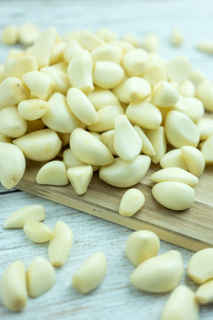Organic garlic on a wooden cutting board pungent flavor, used as seasoning or condiment and in medicine.の写真素材