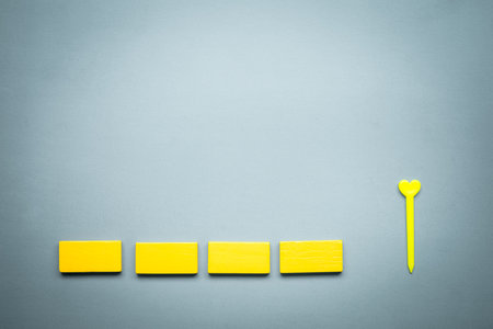 Wooden yellow blocks a row and heart shape. The concept of first date