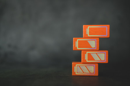 Battery charge indicator on orange wood bar. Charge level with empty space