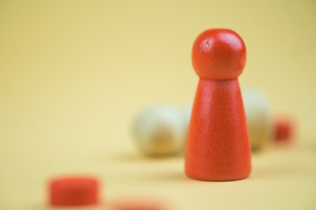 A red wooden figure standing with person figure lie on floor. Concept of successful competition...