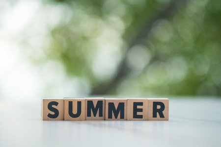 Wooden letters summer on table and against nature background. The concept of a summer.の写真素材