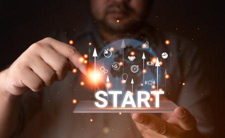 Startup concept. Businessman touching is launching a startup business to fly out with an icon network connection on a modern virtual interface. Business innovation technology conceptの写真素材