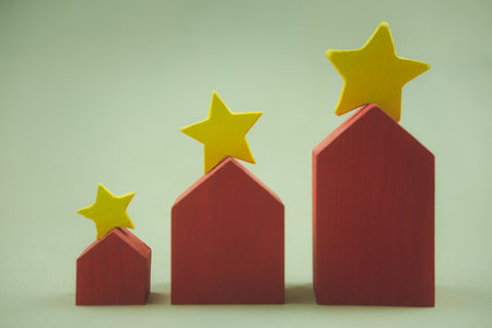 Property assessment and rate with a star. Three size red house with yellow stars on the roof for selection of the best house. Home loan house mortgage agent. The concept of the best housing.の写真素材