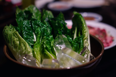 Fresh cos vegetables with ice cubes in grill buffetの写真素材