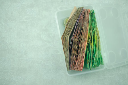 A box filled with Thai baht banknotes. Business saving finance investment concept.の写真素材