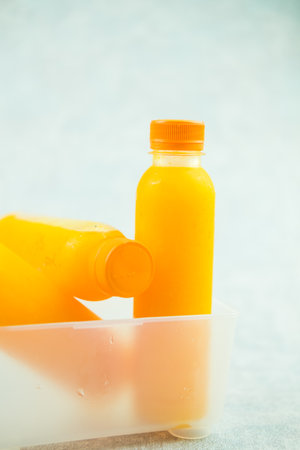 Fresh orange juice in plastic bottle, close-upの写真素材