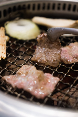 Grilling sliced beef over stove in Japanese food styleの写真素材