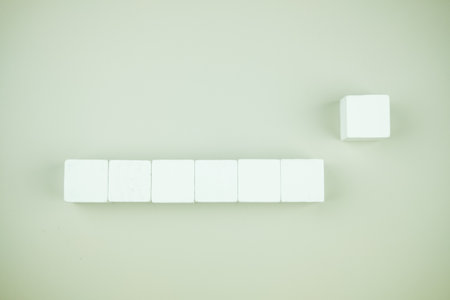One wooden block stands out from the group wooden blocks. Leadership, dissenting opinion, divergent...