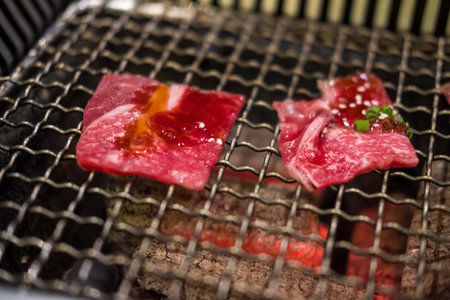 Grilling wagyu beef on charcoal grill. Close upの写真素材