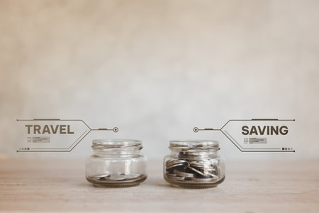 Two glass jar with coins and text for planning to saving and travel. Save money for the future during retirement. Coins in glass jars for different needs in the future.の写真素材