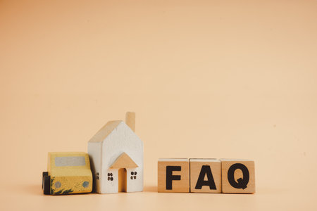 Wood cubes with acronym faq frequently asked questions about of car and home. The concept of support customer befor and after buy home and home. Wood toy car and wood toy home with FAQ.の写真素材