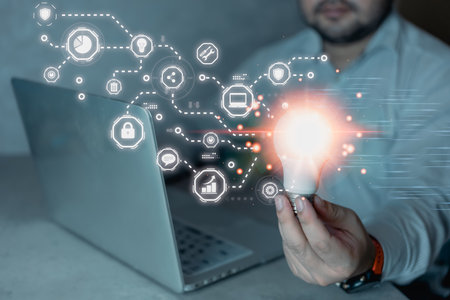 Man hand holding light bulb connection business global virtual screen. Creativity and innovation are...