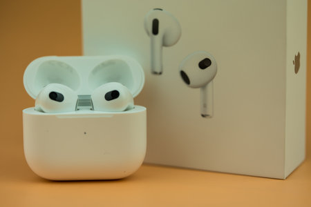 Bangkok, Thailand - November 19, 2022 : The Charging case next to New Apple Computers AirPods 3 Bluetooth headphones with Active Noise Cancellation for immersive soundのeditorial素材