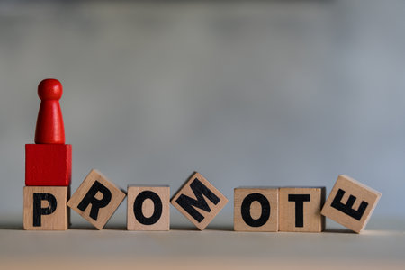 Wooden red figures peg doll stand on wood text of promote. Ladder career path concept in organization. A key essential employee. Irreplaceable valuable employee. Specialist and professional.の写真素材