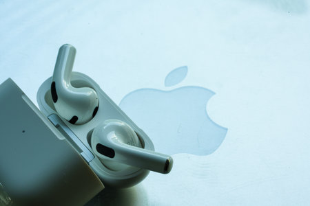 Bangkok, Thailand - November 21, 2022 : Closeup of new wireless headphones apple AirPods 3 on a silver Macbook Pro placed near the logo macのeditorial素材