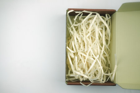 Open carton corrugated cardboard box with prevent bumping yellow paper. Top view