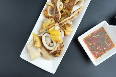 BBQ Squid. grilled buttered fresh squid ready to eat served together Thai seafood sauceの写真素材